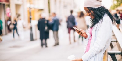 mulher-usando-aplicativos-para-celular-na-rua